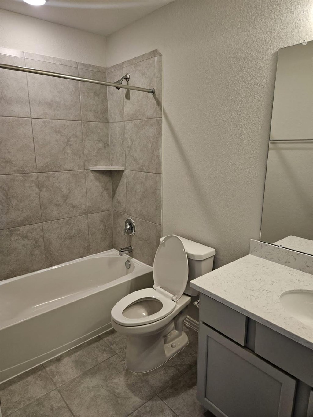 a bathroom with a toilet and a tub and a sink