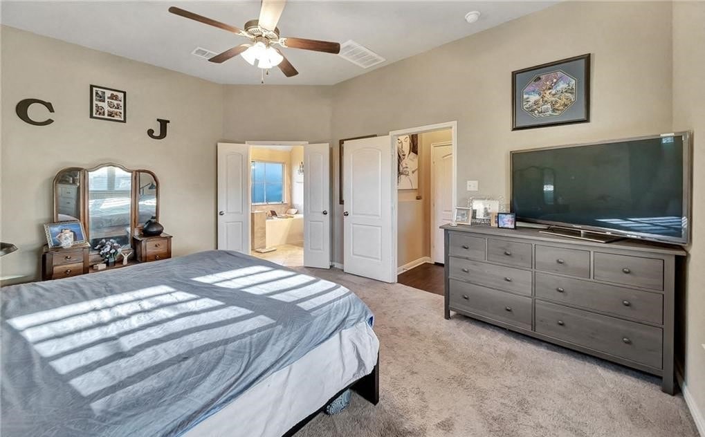 a bedroom with a bed and a tv