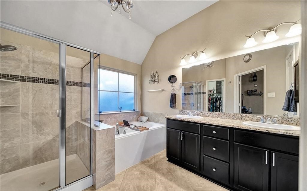 a bathroom with a tub and a shower and a sink