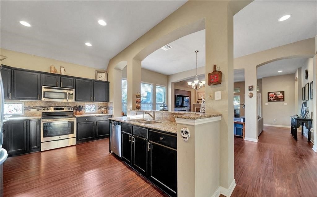 a large kitchen with black cabinets and a counter top