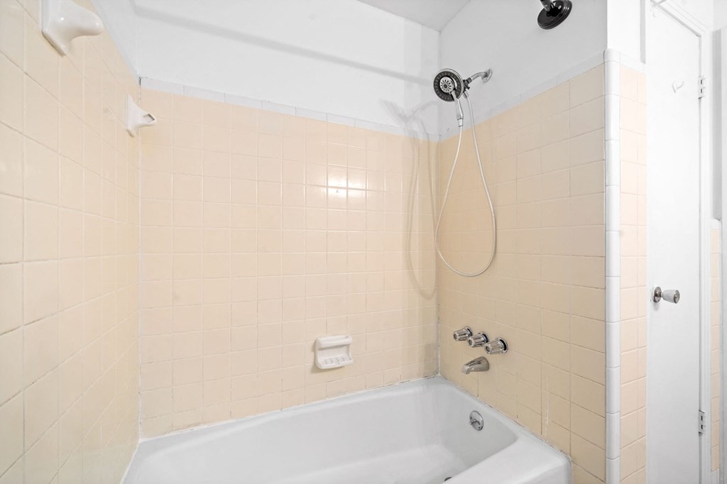 a bathroom with a tub and a shower
