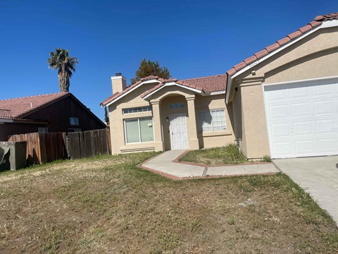 a home with a white garage door and a yard