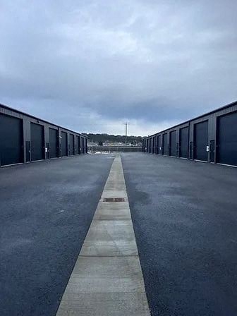 an empty parking lot with rows of garages