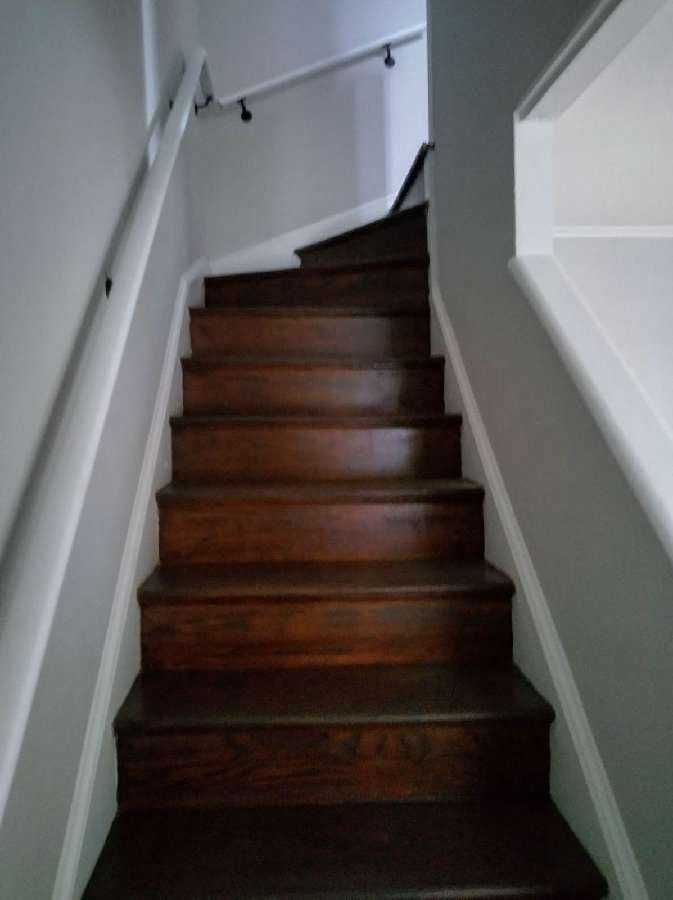 stairs in a home with wooden steps