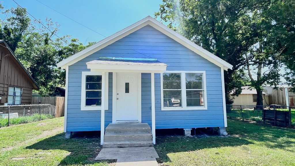 a blue house with a white front door and a porch