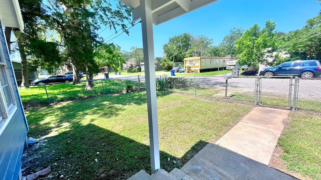 the front yard of a house with cars parked in the yard