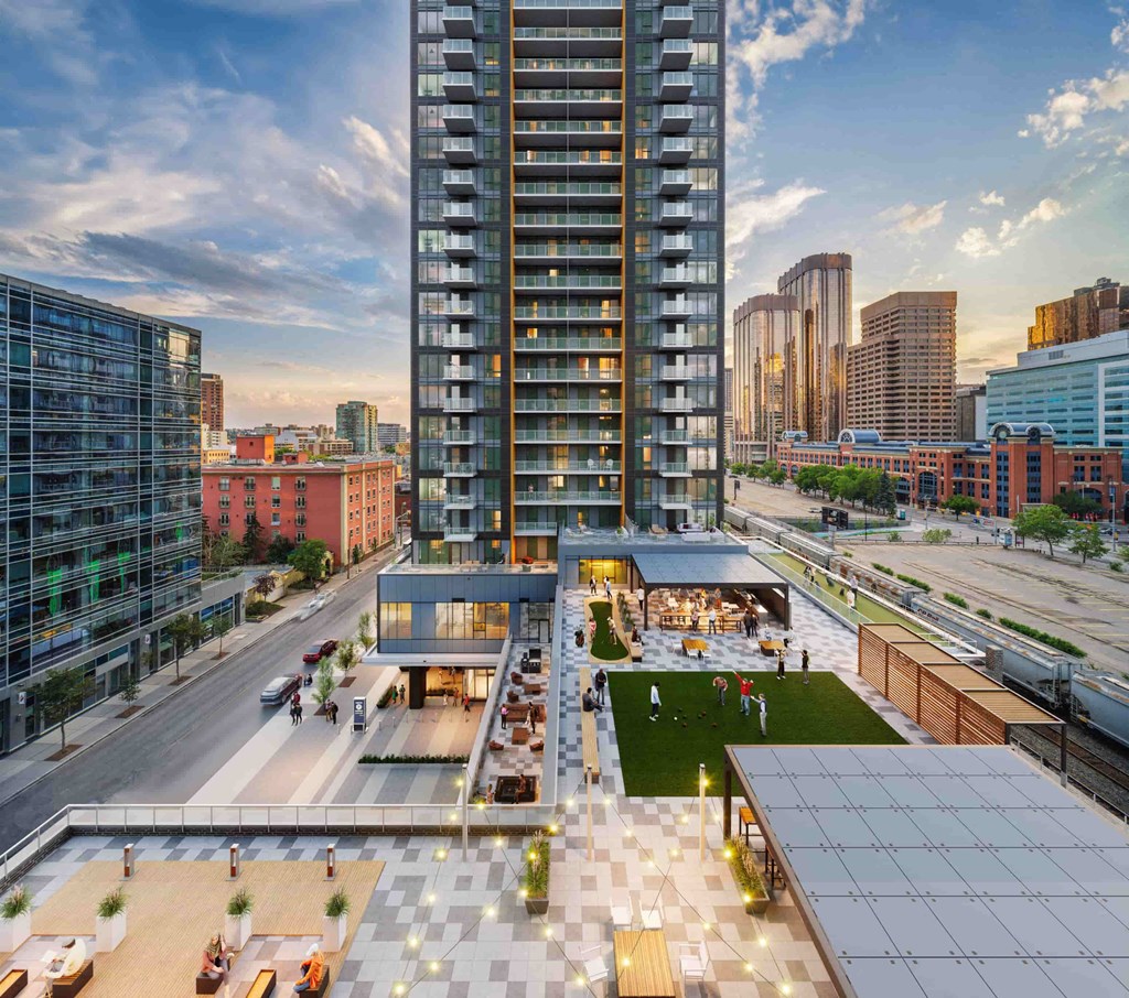 an aerial view of a city with a skyscraper and a park