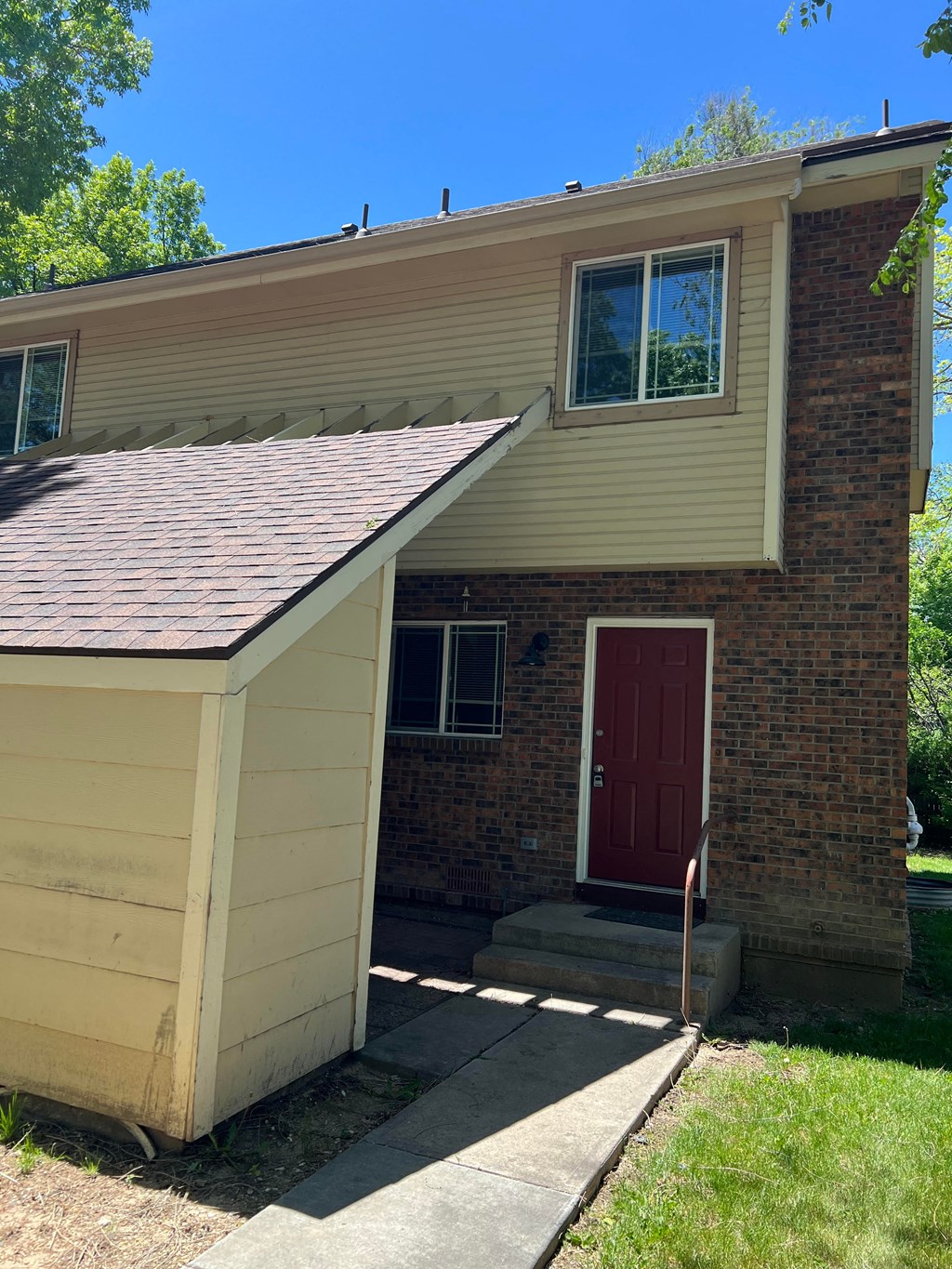a house with a porch and a red door