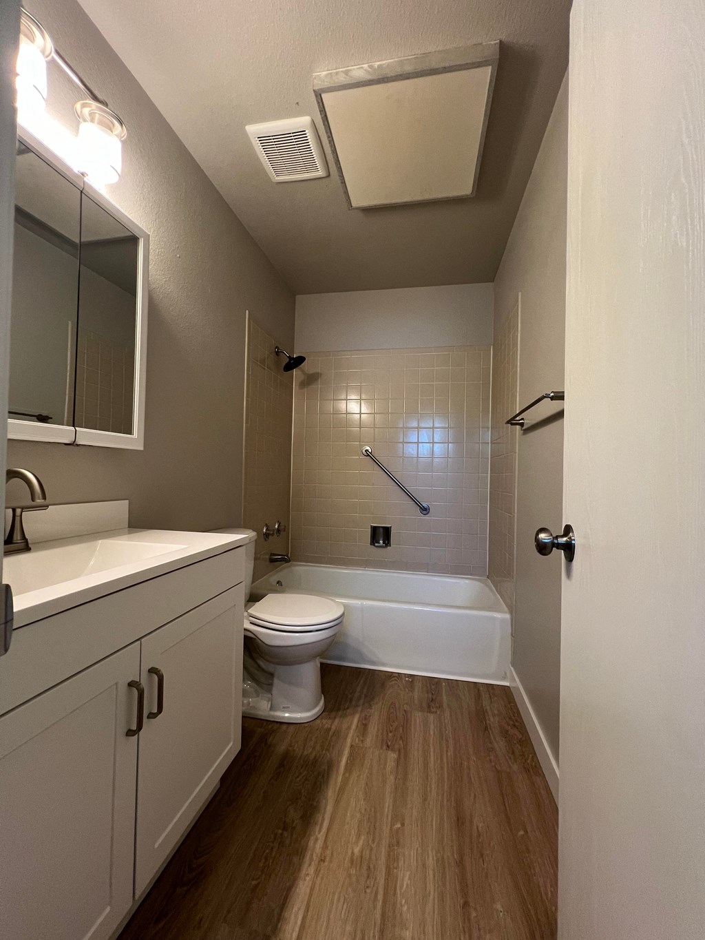 a bathroom with a toilet and a tub and a sink