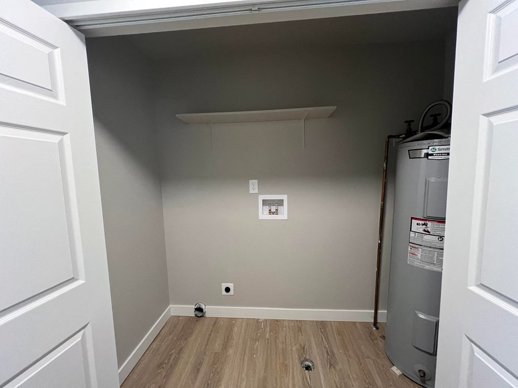 a room with gray walls and a closet and a refrigerator