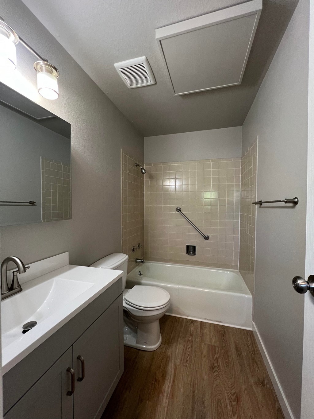 a bathroom with a toilet and a tub and a sink