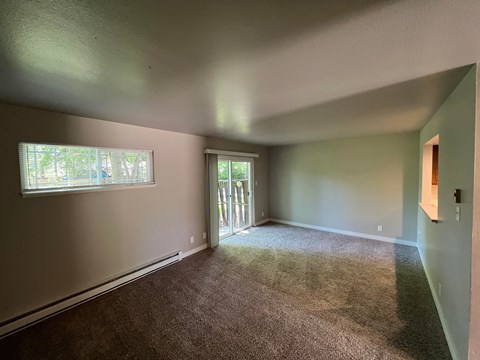 the living room of an empty house with a window