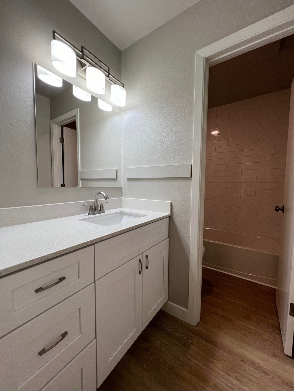 an empty bathroom with a sink and a mirror