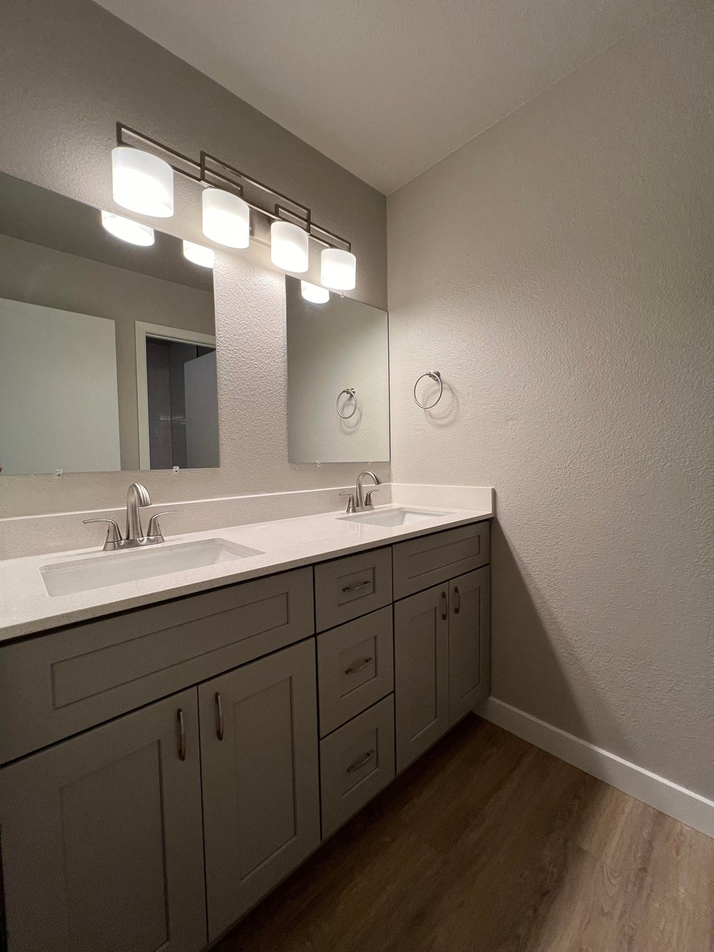 a bathroom with two sinks and a mirror