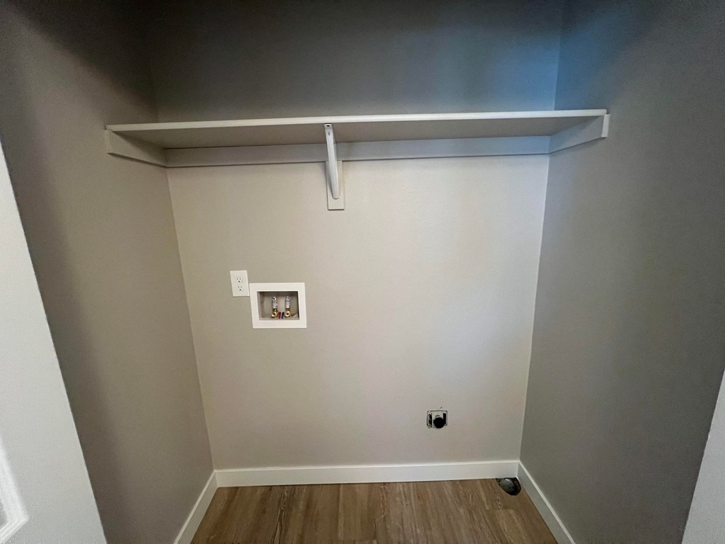 a room with a white wall and a white shelf on top of it