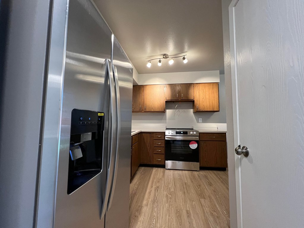 a kitchen with stainless steel appliances and wooden cabinets