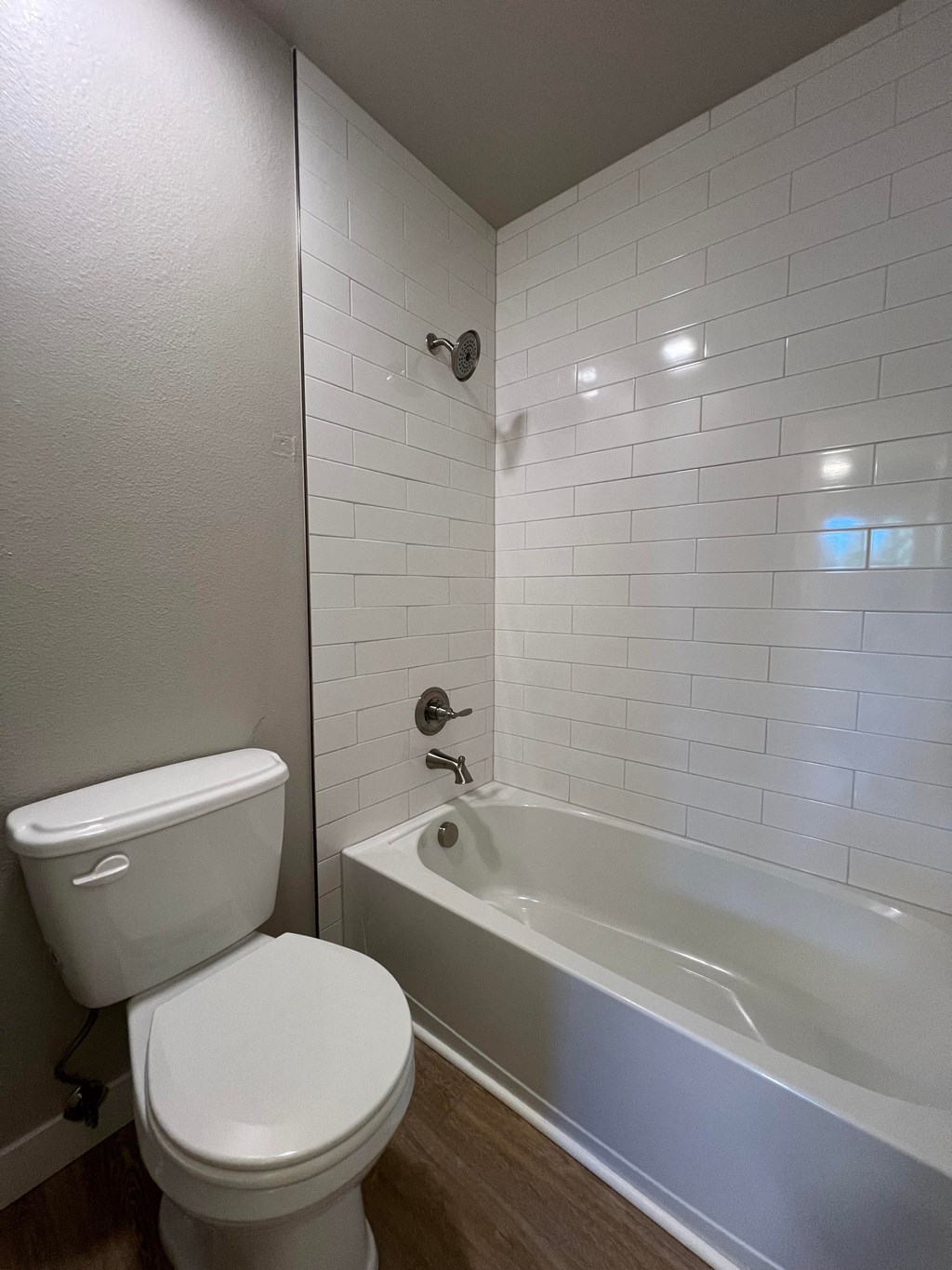 a bathroom with a toilet and a bath tub