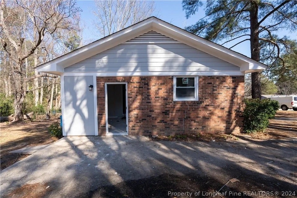 a small brick house with an open door