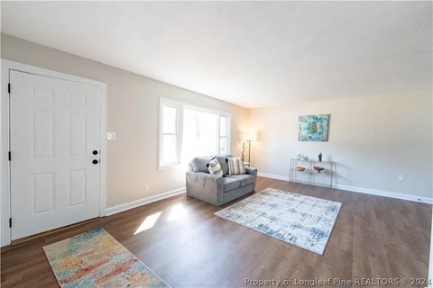 a living room with a couch and a white door
