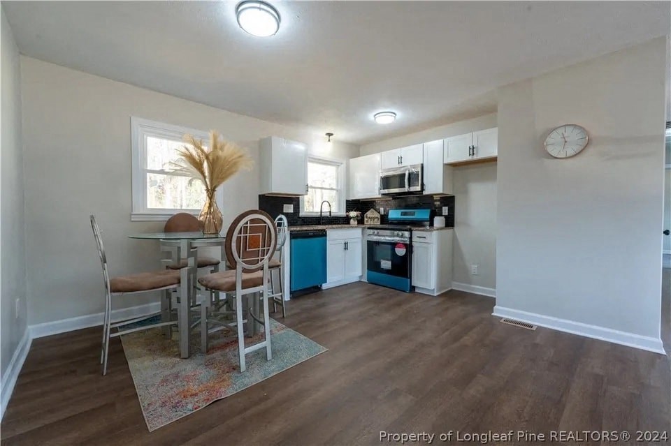 a kitchen and dining area with a table and chairs
