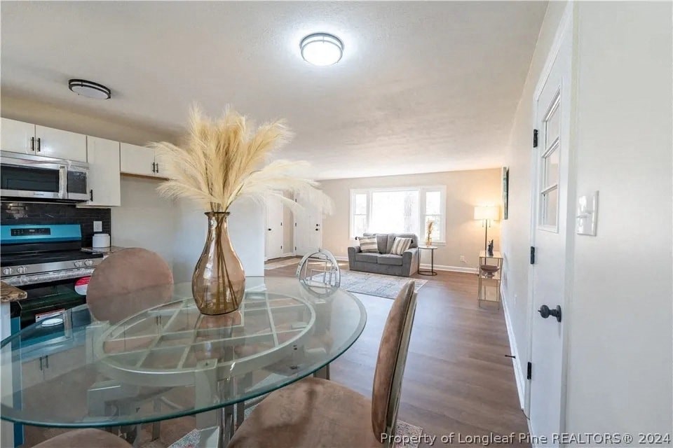 a living room and dining room with a glass table