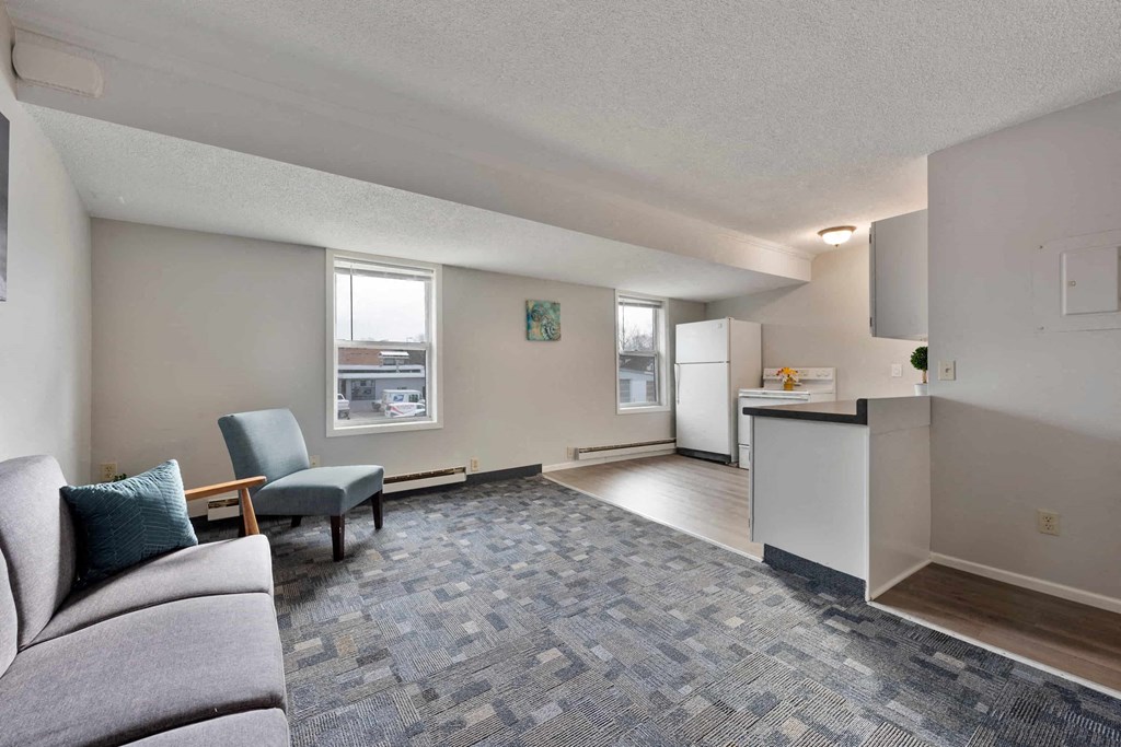 a living room and kitchen with a couch and a table