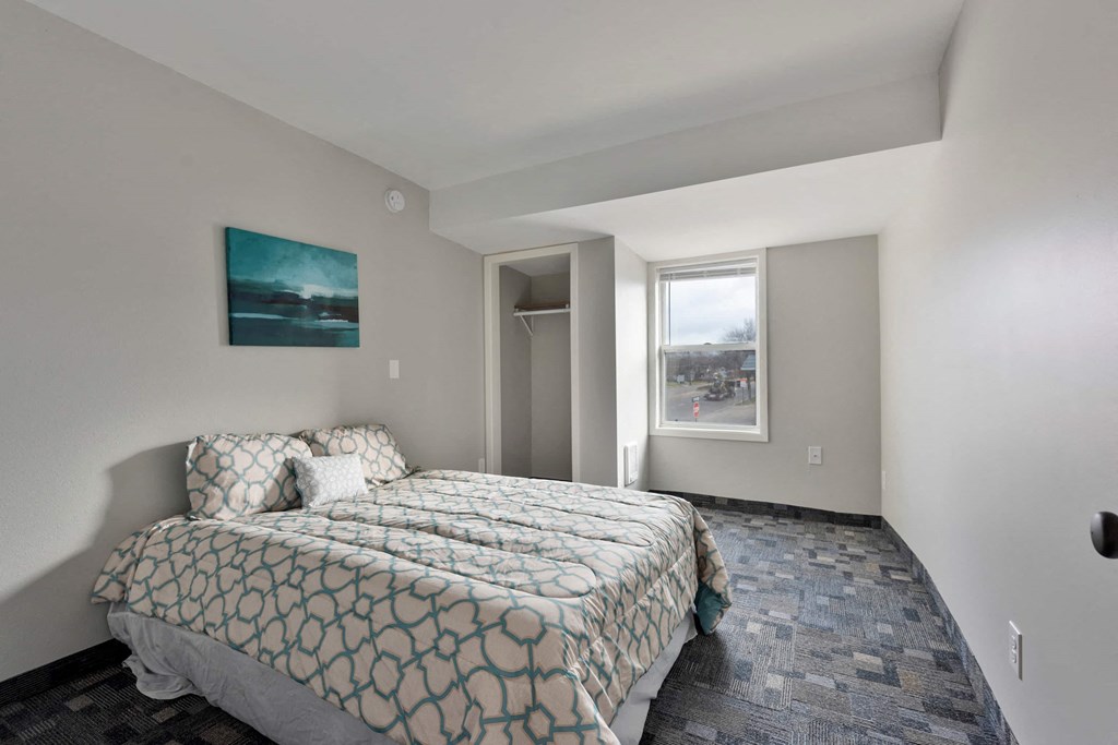 a bedroom with a bed and a window