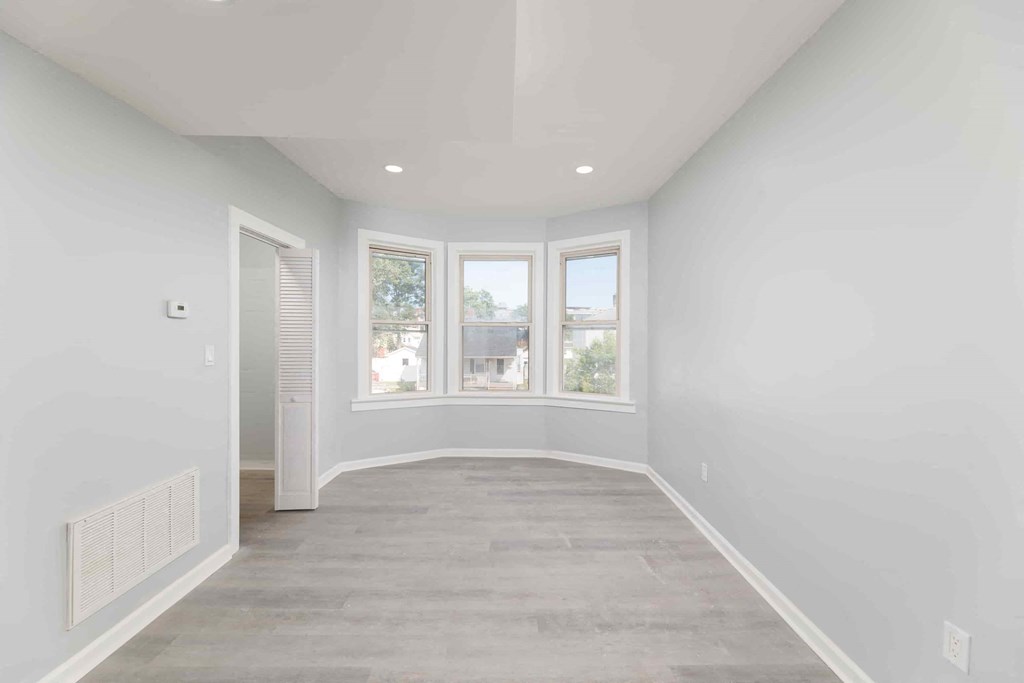 a white room with a window and a door