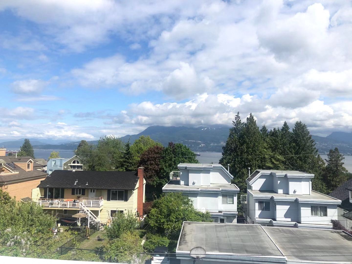 a view of a neighborhood with houses and a body of water
