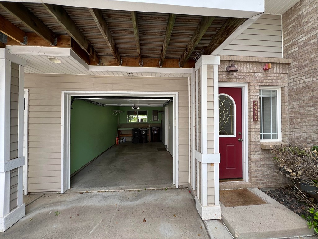 the entrance to a parking garage with a red door and a green wall