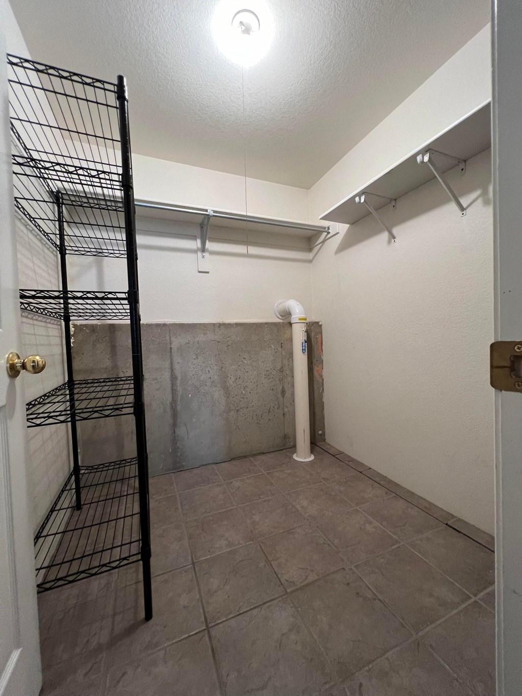 a large room with a large closet and a tile floor