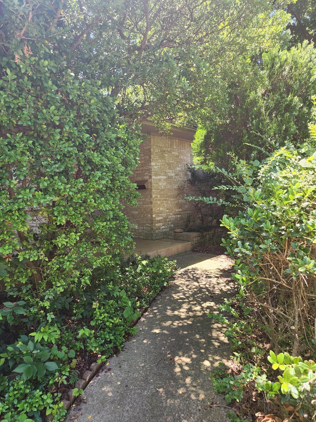 a path leading to a brick wall