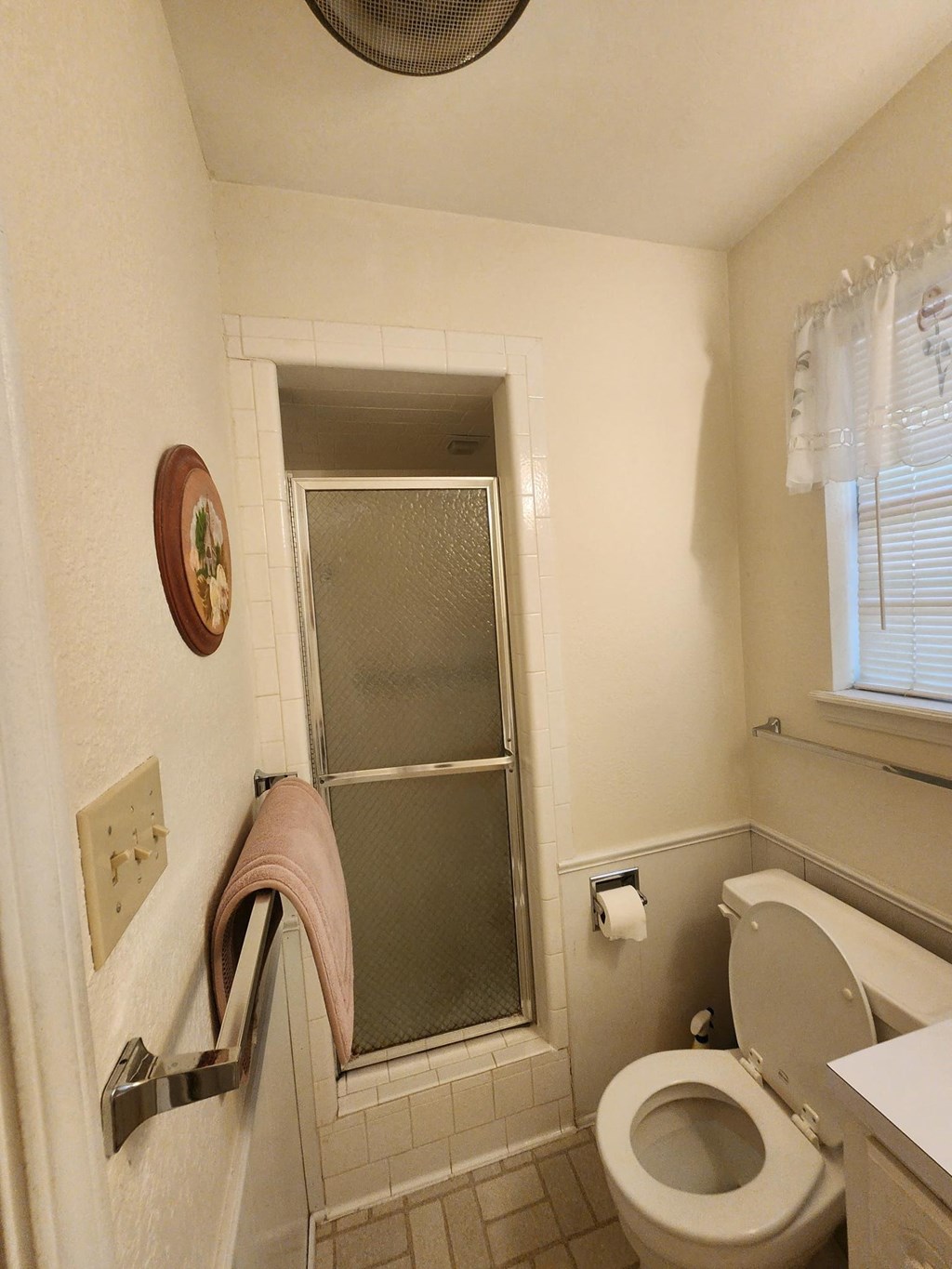 a small bathroom with a toilet and a shower