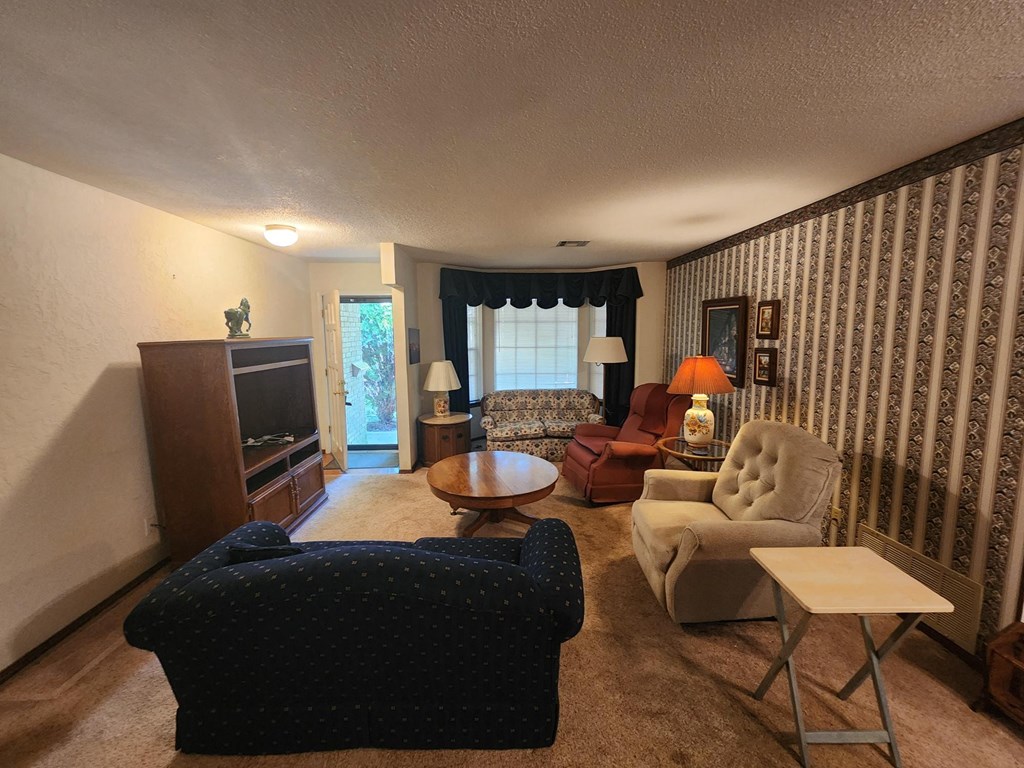 a living room filled with furniture and a tv
