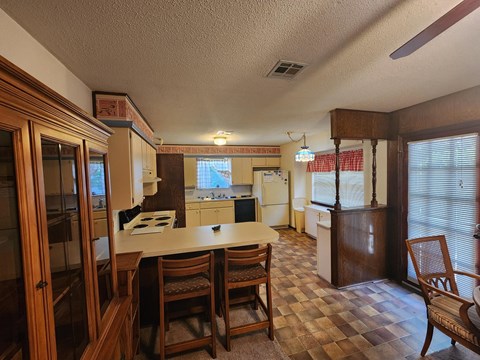a kitchen and dining room with a table and chairs