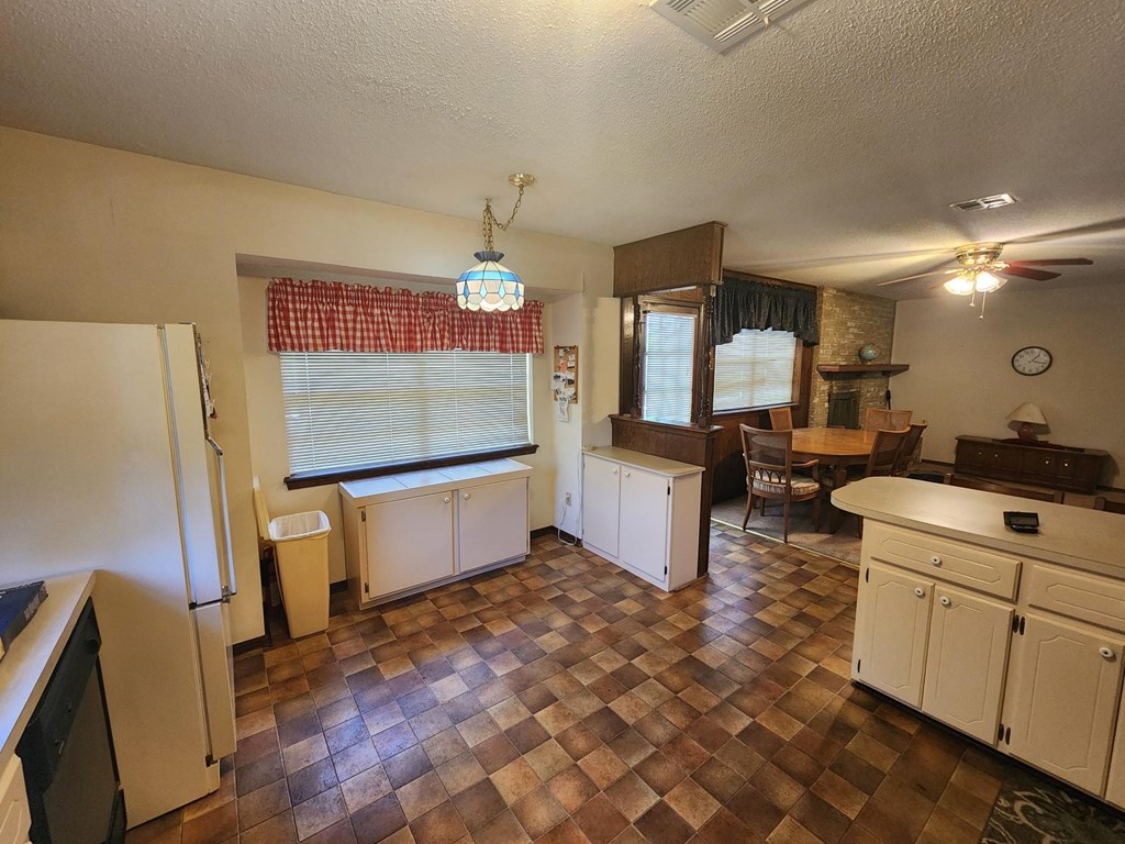 a kitchen with a dining room and a living room