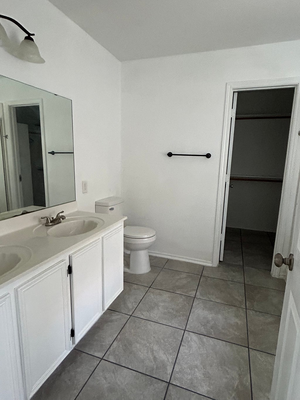 an empty bathroom with a toilet and a sink
