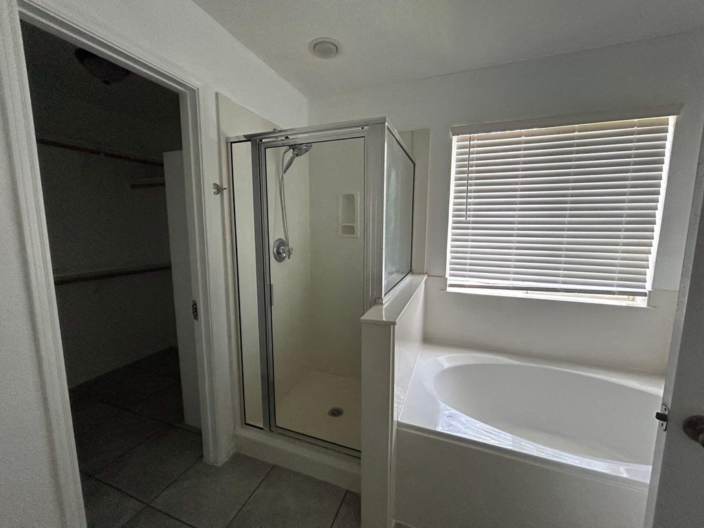 a small bathroom with a tub and a shower