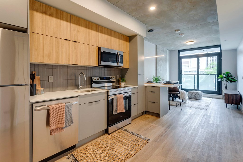 a kitchen with wooden cabinets and stainless steel appliances