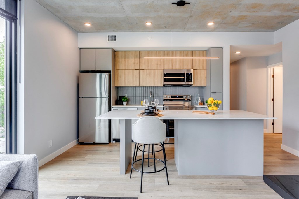 a kitchen with a large island with two stools