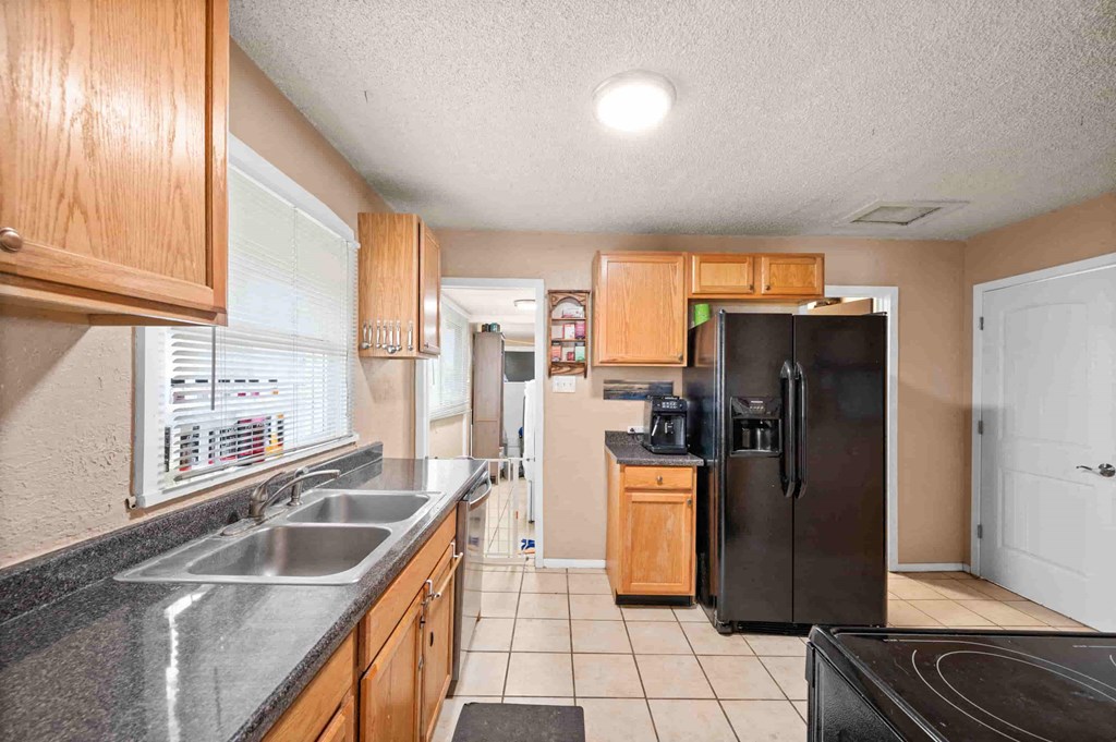 a kitchen with a sink and a refrigerator