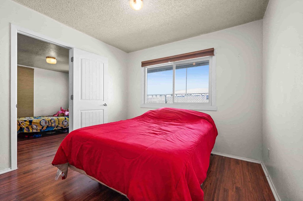 a bedroom with a bed and a door to a closet