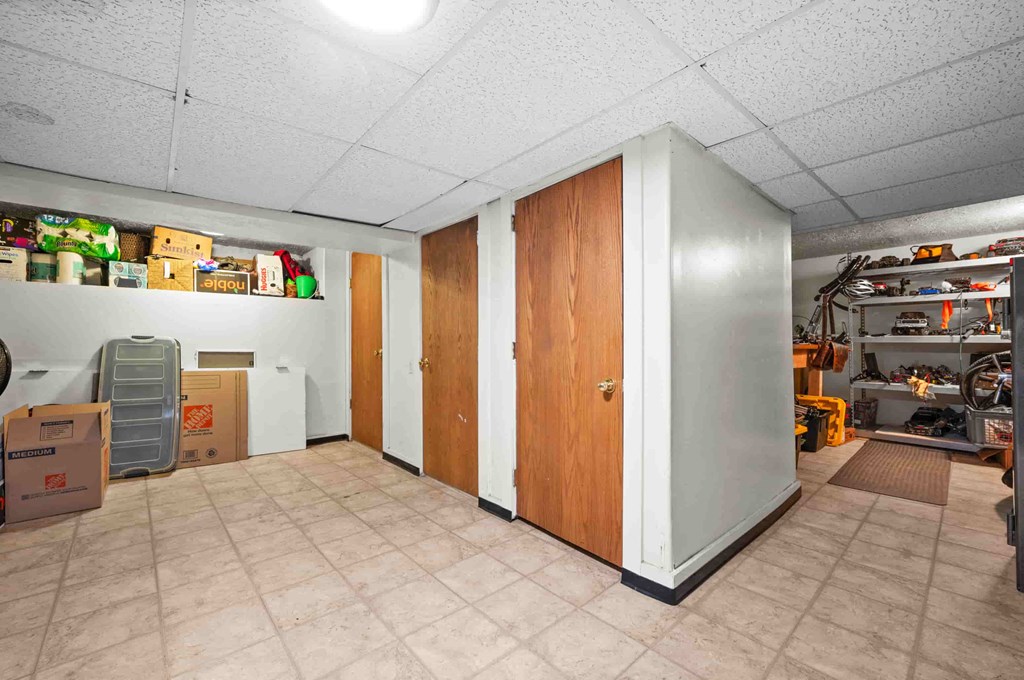 the storage room in the basement of a home with boxes and shelves on the wall
