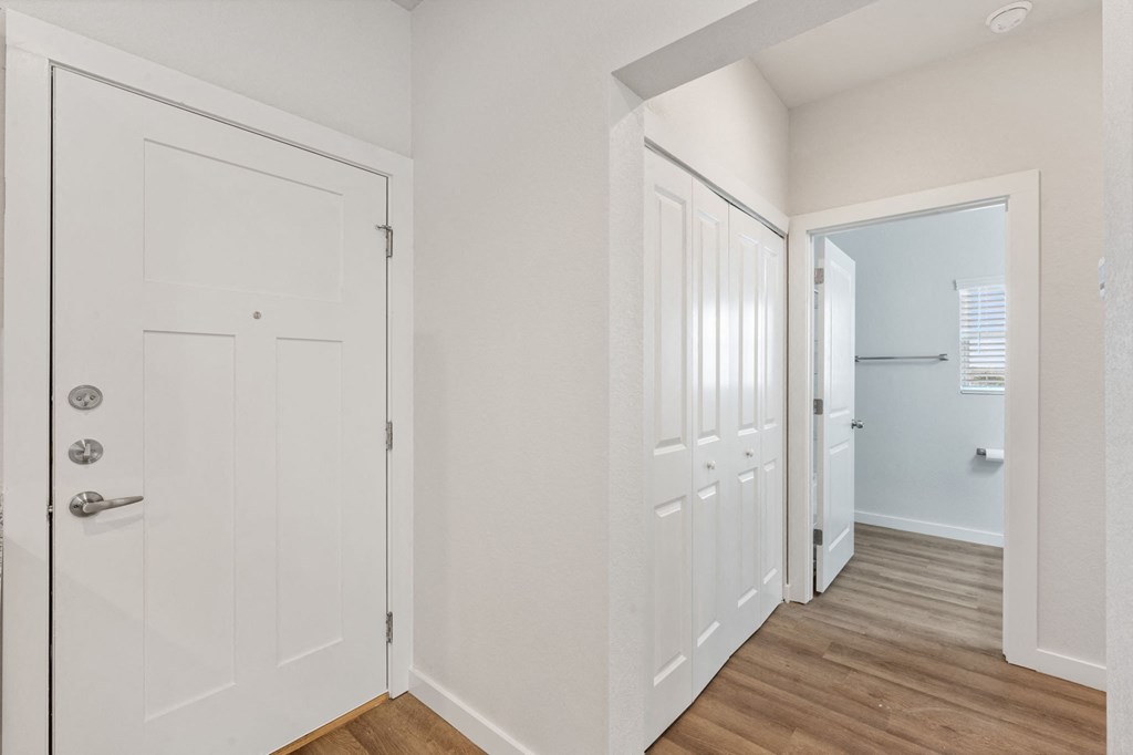 a bedroom with white doors and a door to a closet