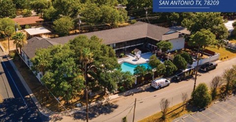an aerial view of a house with a swimming pool