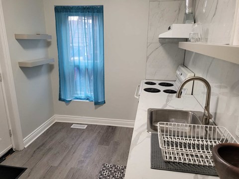 a small kitchen with a sink and a window