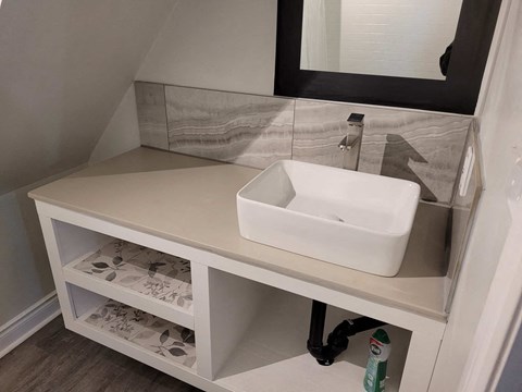 a small bathroom with a sink and a mirror