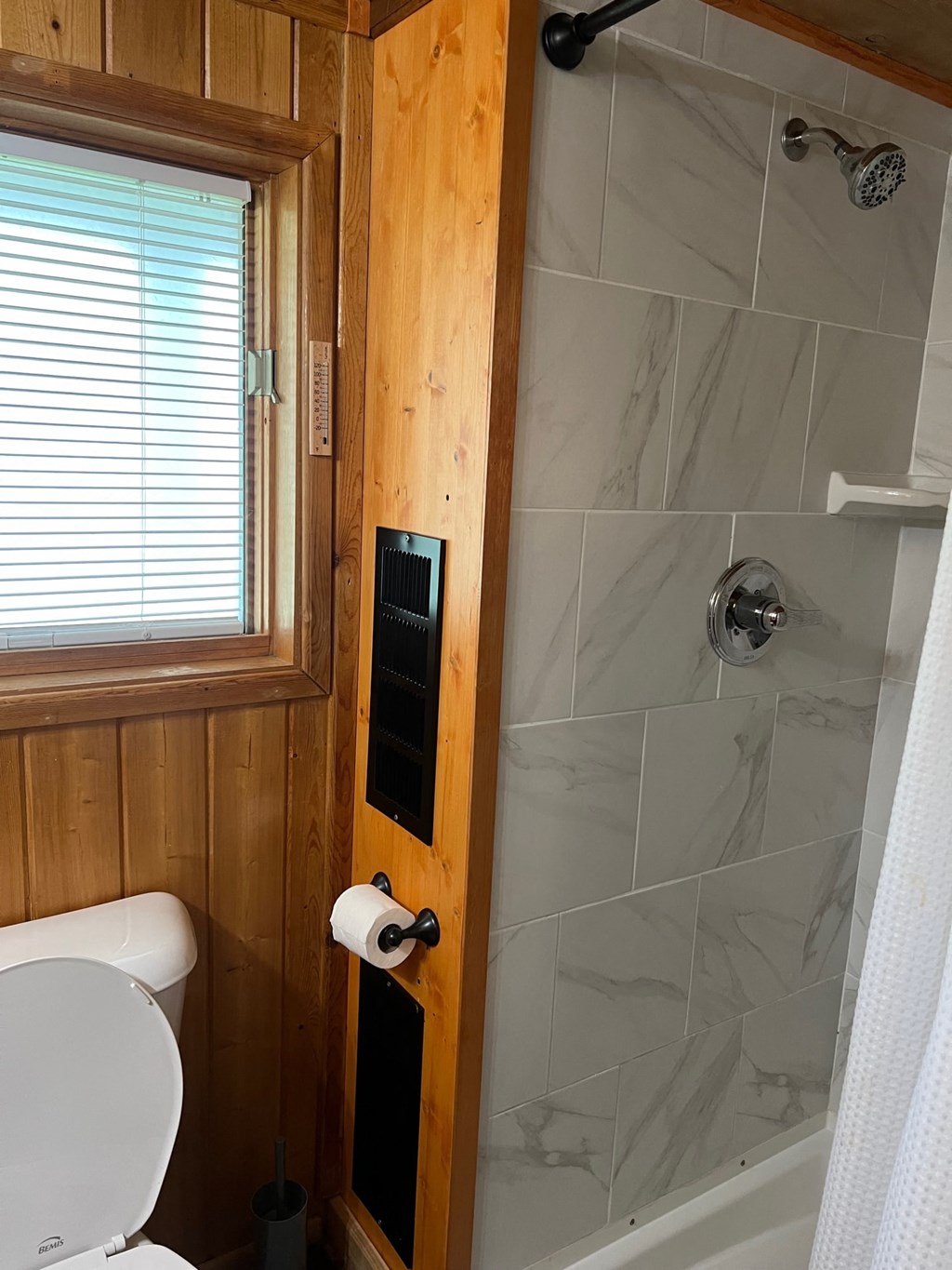 a small bathroom with a toilet and a shower
