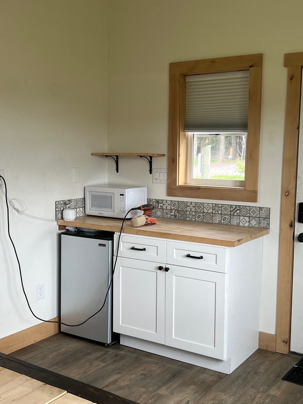 a small kitchen with a washer and dryer and a window