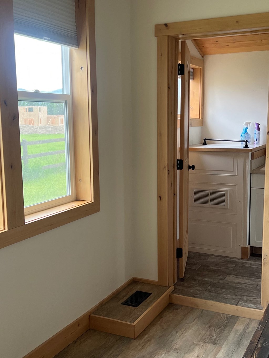 a view of the kitchen from the living room with the door open